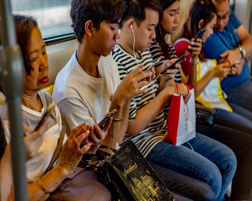 Person riding public transport looking at their phone