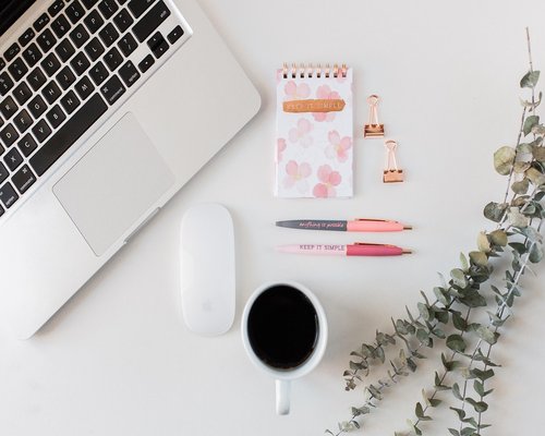 Organized modern desk with coffee and notebook